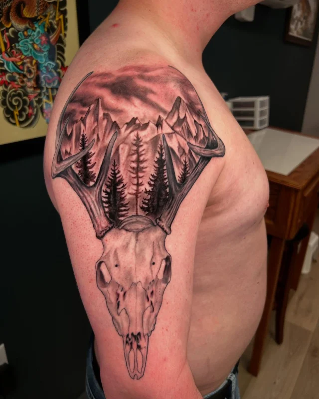 Finished this upper arm on @tayler__dow today!  Tattooed just the skull a few months ago and added the mountains today!  Thanks for hanging tough bud!